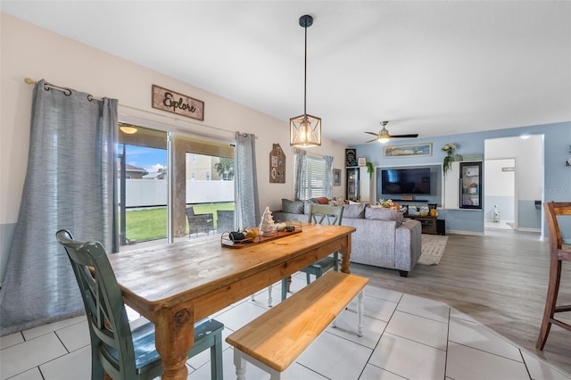 dining space featuring light tile patterned floors and ceiling fan