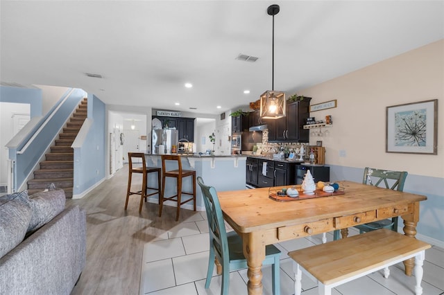 dining area featuring recessed lighting, visible vents, baseboards, and stairs