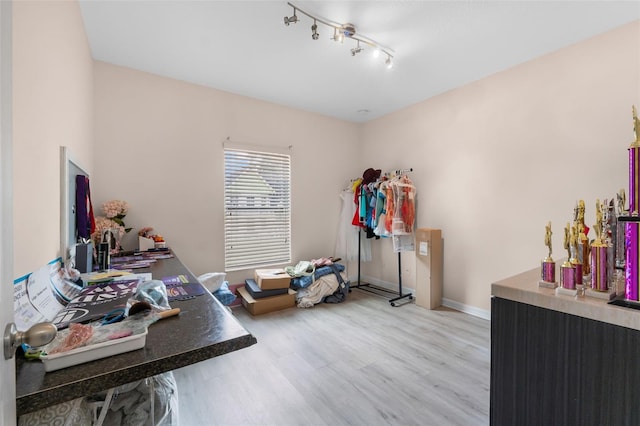 home office featuring light wood-type flooring and baseboards
