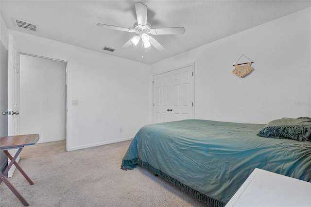 carpeted bedroom with baseboards, visible vents, and ceiling fan