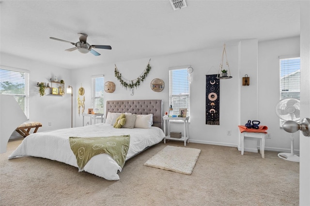 bedroom with multiple windows, carpet flooring, and visible vents