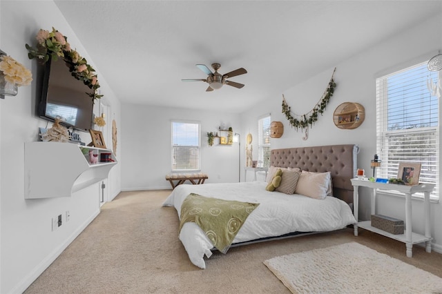 carpeted bedroom with baseboards and a ceiling fan