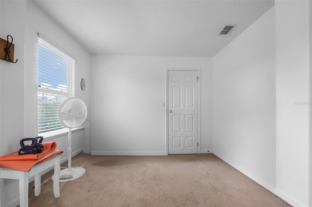 interior space featuring baseboards, visible vents, and carpet floors