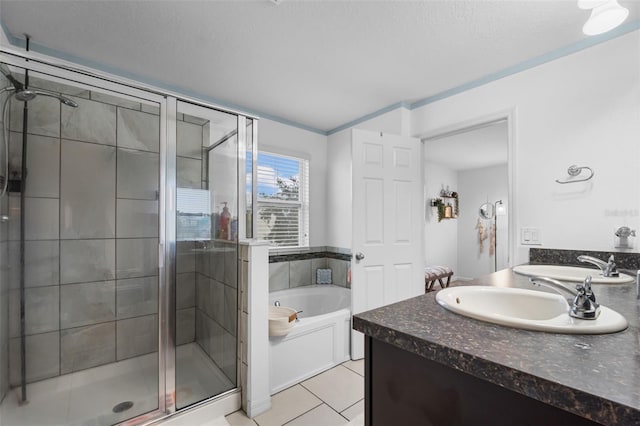 bathroom featuring vanity, a garden tub, a shower stall, and tile patterned flooring