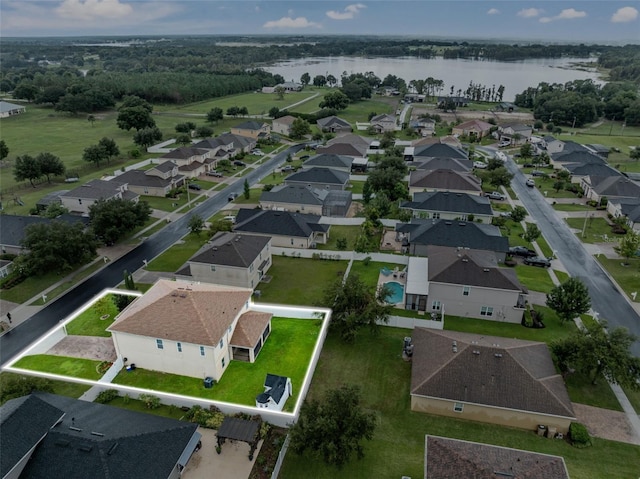 drone / aerial view with a residential view and a water view