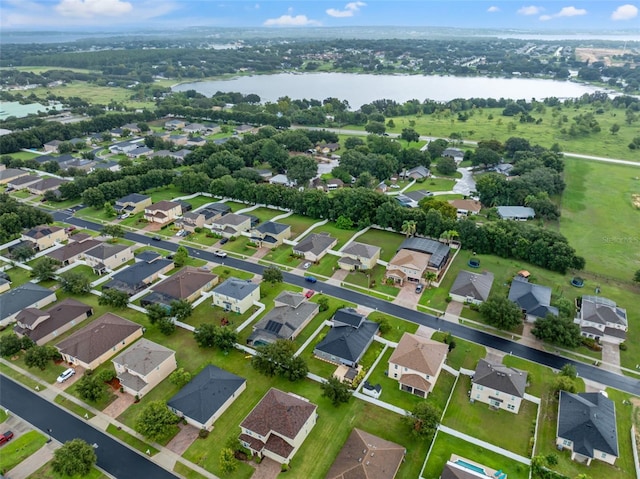 birds eye view of property featuring a water view and a residential view