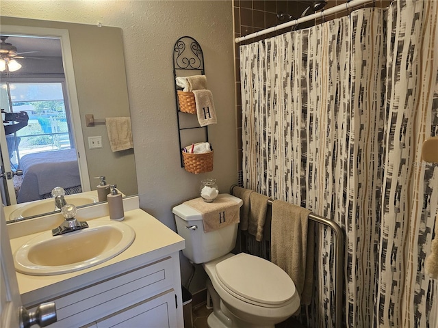 4529 Mercado Dr, Sebring, FL 33872 - bathroom with a shower with shower curtain, ceiling fan, toilet, vanity, and a textured wall