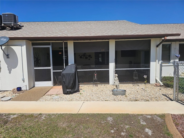 4529 Mercado Dr, Sebring, FL 33872 - exterior space featuring cooling unit, a sunroom, fence, and roof with shingles