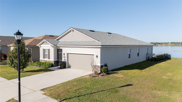 169 Summershore Dr, Auburndale, FL 33823 - view of front facade featuring stucco siding, an attached garage, a front lawn, concrete driveway, and a water view