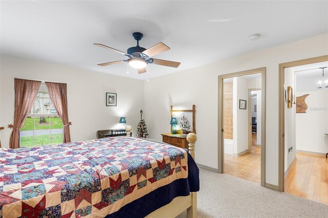 5020 Broadmore Dr, Auburndale, FL 33823 - bedroom with light colored carpet, baseboards, ceiling fan, access to outside, and connected bathroom