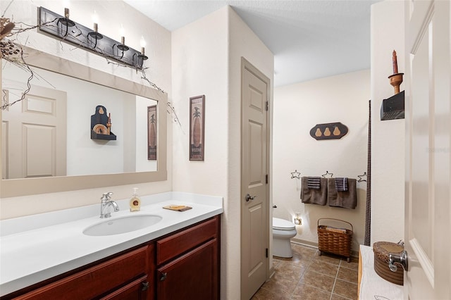 5020 Broadmore Dr, Auburndale, FL 33823 - bathroom with toilet, vanity, baseboards, and tile patterned floors
