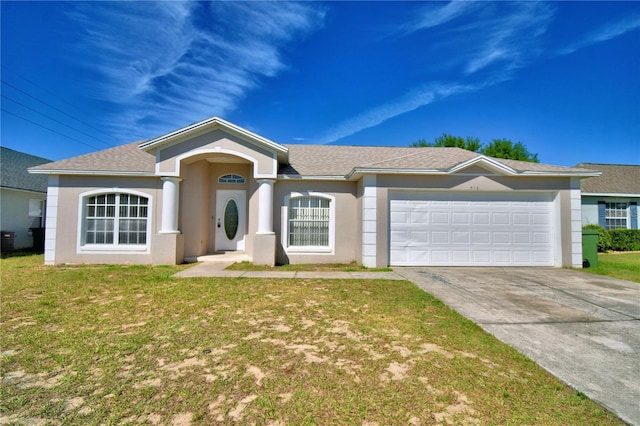 ranch-style home featuring stucco siding, an attached garage, a front lawn, and concrete driveway