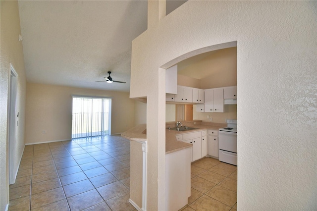 kitchen featuring a sink, light tile patterned floors, electric stove, arched walkways, and ceiling fan