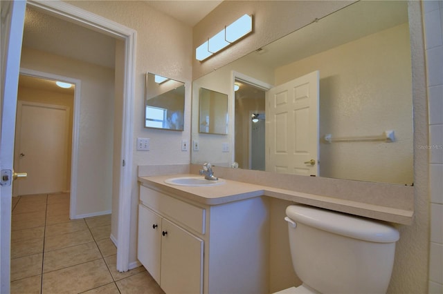 bathroom with tile patterned floors, toilet, and vanity