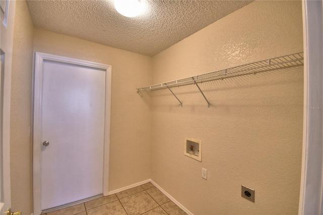 clothes washing area featuring light tile patterned flooring, a textured ceiling, washer hookup, laundry area, and electric dryer hookup