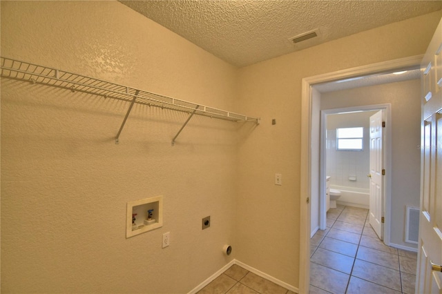 washroom with visible vents, washer hookup, laundry area, and electric dryer hookup