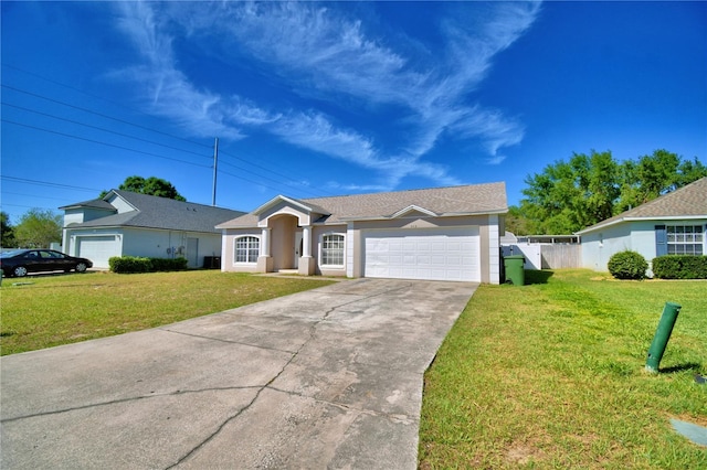 ranch-style home featuring driveway, a front lawn, fence, and an attached garage