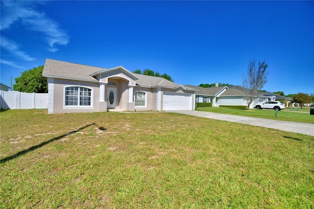 ranch-style house with driveway, an attached garage, fence, and a front lawn