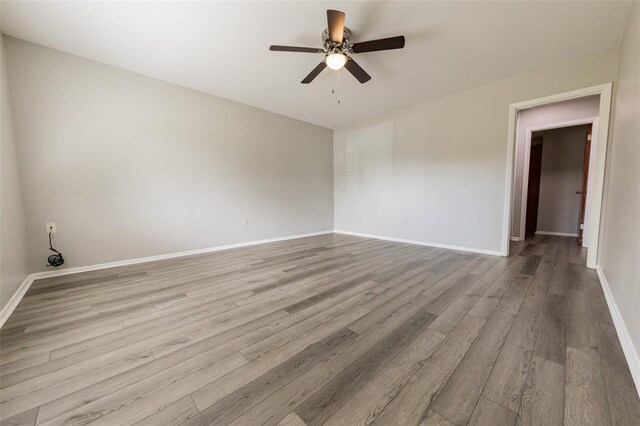 1801 3rd Ct SE, Winter Haven, FL 33880 - spare room featuring a ceiling fan, wood finished floors, and baseboards