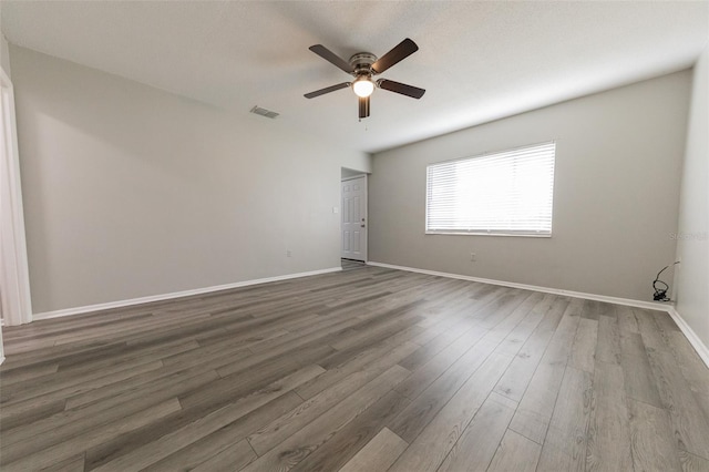 1801 3rd Ct SE, Winter Haven, FL 33880 - spare room with ceiling fan, wood finished floors, and baseboards