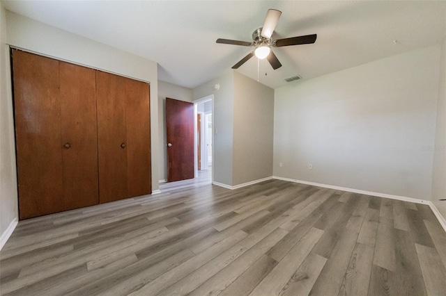 1801 3rd Ct SE, Winter Haven, FL 33880 - unfurnished bedroom with a closet, wood finished floors, and baseboards