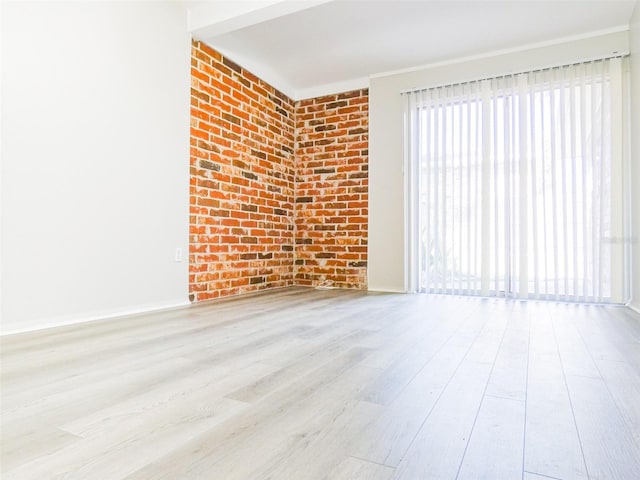 1801 3rd Ct SE, Winter Haven, FL 33880 - empty room with wood finished floors, baseboards, and brick wall