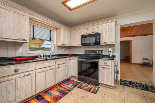 225 Wes Mann Rd, Babson Park, FL 33827 - kitchen with light tile patterned flooring, black appliances, a sink, and light brown cabinets