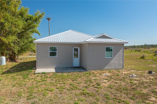 225 Wes Mann Rd, Babson Park, FL 33827 - back of house featuring a lawn and metal roof