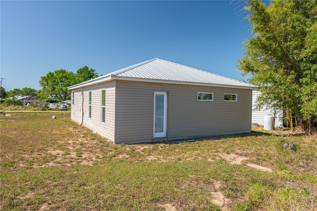 225 Wes Mann Rd, Babson Park, FL 33827 - view of home's exterior featuring a lawn and metal roof