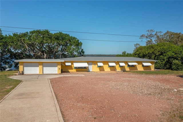 225 Wes Mann Rd, Babson Park, FL 33827 - view of front of house featuring stucco siding, a garage, and concrete driveway