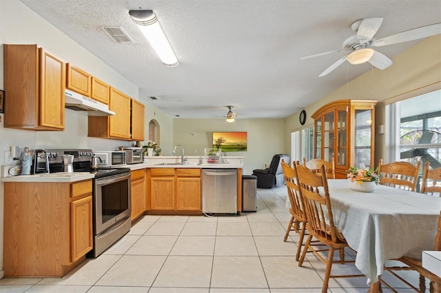 247 Cobalt Dr, Kissimmee, FL 34758 - kitchen featuring ceiling fan, stainless steel appliances, light countertops, under cabinet range hood, and a peninsula