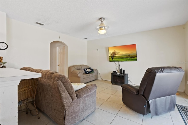 247 Cobalt Dr, Kissimmee, FL 34758 - living area with light tile patterned floors, visible vents, a textured ceiling, and arched walkways