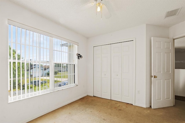 247 Cobalt Dr, Kissimmee, FL 34758 - unfurnished bedroom with baseboards, visible vents, carpet floors, and multiple windows