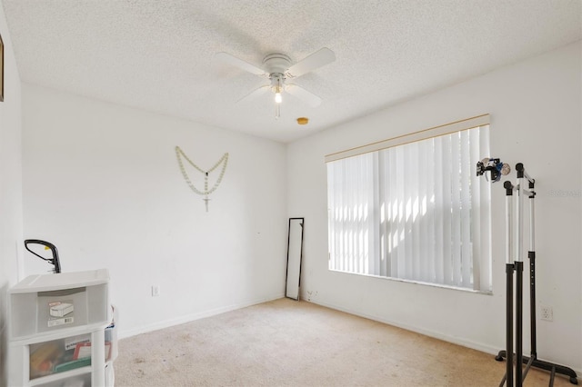 247 Cobalt Dr, Kissimmee, FL 34758 - spare room featuring a textured ceiling, ceiling fan, carpet, and baseboards