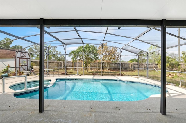 247 Cobalt Dr, Kissimmee, FL 34758 - view of pool featuring glass enclosure, a fenced backyard, a pool with connected hot tub, and a patio area