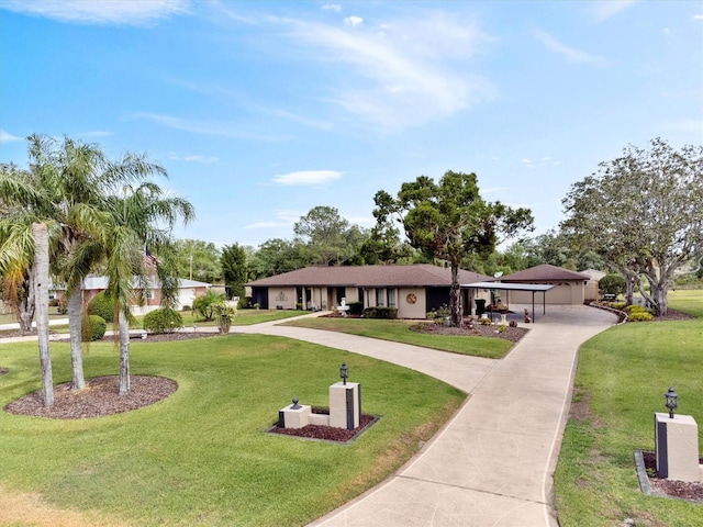 view of front facade with a front yard and curved driveway