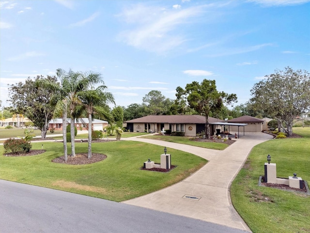 surrounding community featuring a lawn and curved driveway