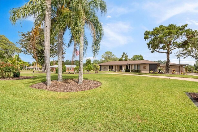ranch-style house with stucco siding and a front lawn