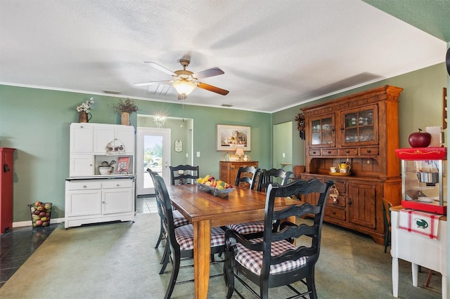 dining room featuring crown molding, a textured ceiling, visible vents, and a ceiling fan