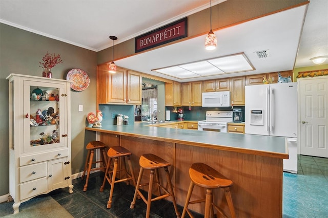 kitchen featuring white appliances, visible vents, decorative light fixtures, and a sink