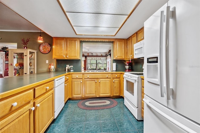 kitchen featuring white appliances and a sink