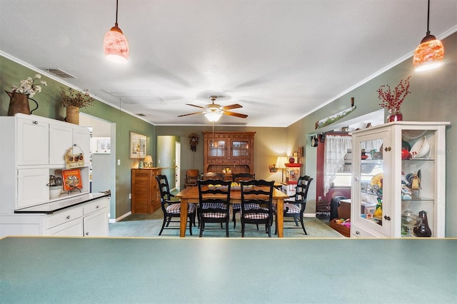 dining area with a ceiling fan, crown molding, baseboards, and visible vents