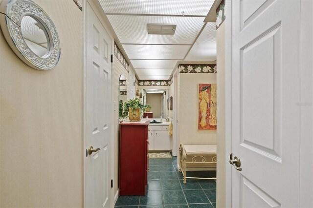 hallway featuring dark tile patterned floors
