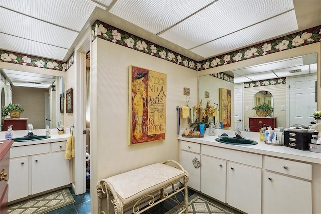 full bathroom with a sink and two vanities