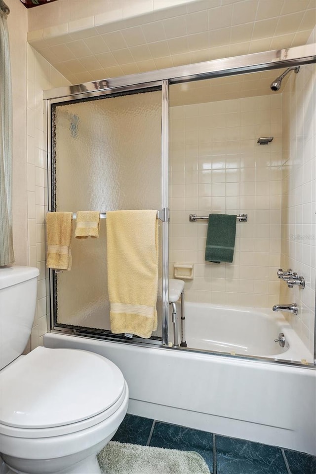 full bathroom with enclosed tub / shower combo, toilet, and tile patterned flooring