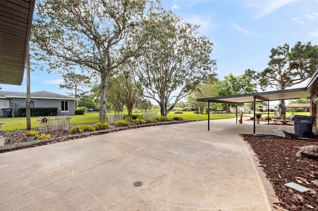 view of patio / terrace featuring driveway and fence