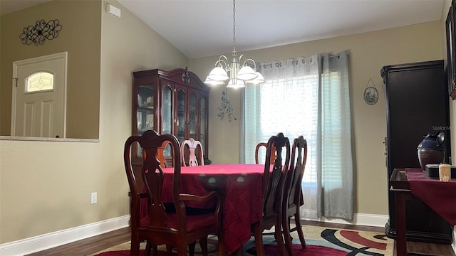 214 Brook Ln, Polk City, FL 33868 - dining room with baseboards, vaulted ceiling, wood finished floors, and a chandelier