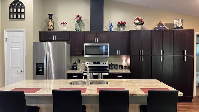 214 Brook Ln, Polk City, FL 33868 - kitchen featuring light stone countertops, a breakfast bar, a sink, and stainless steel appliances