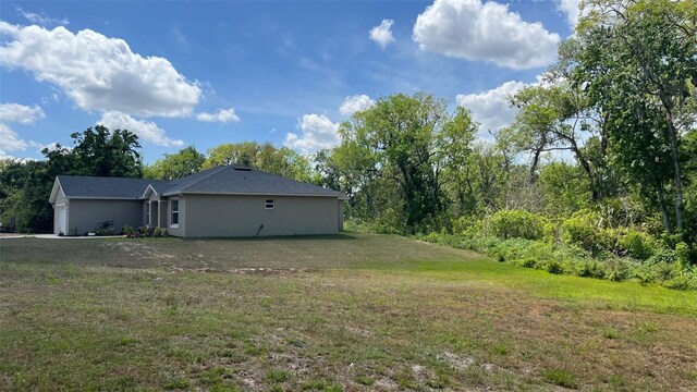 214 Brook Ln, Polk City, FL 33868 - view of yard with a garage
