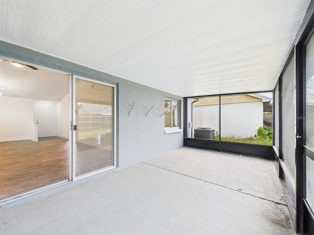 unfurnished sunroom with ceiling fan